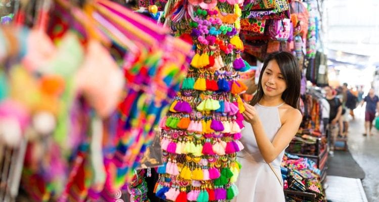 Best Thailand Souvenirs Young woman shopping at street market