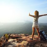 How to Quit Your Job to Travel the World - backpacker on a mountaintop