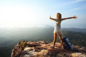 How to Quit Your Job to Travel the World - backpacker on a mountaintop