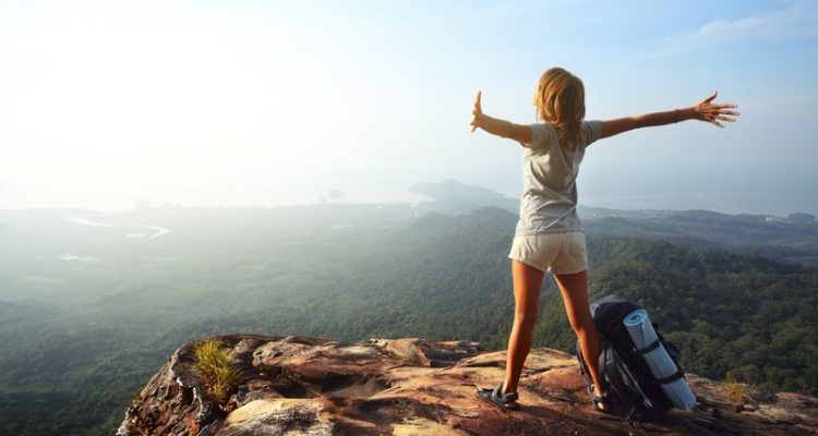 How to Quit Your Job to Travel the World - backpacker on a mountaintop