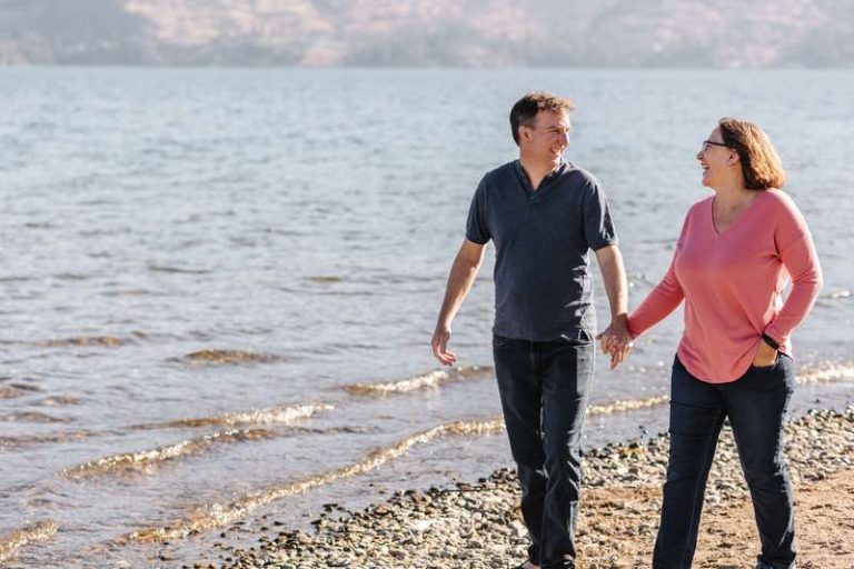 couple walking along beach in West Kelowna BC personal photographer for a day