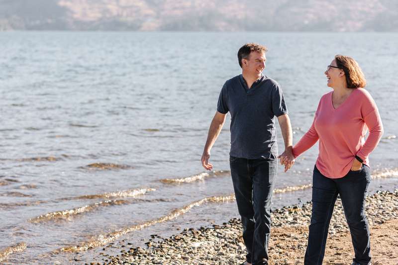 couple walking along beach in West Kelowna BC personal photographer for a day 