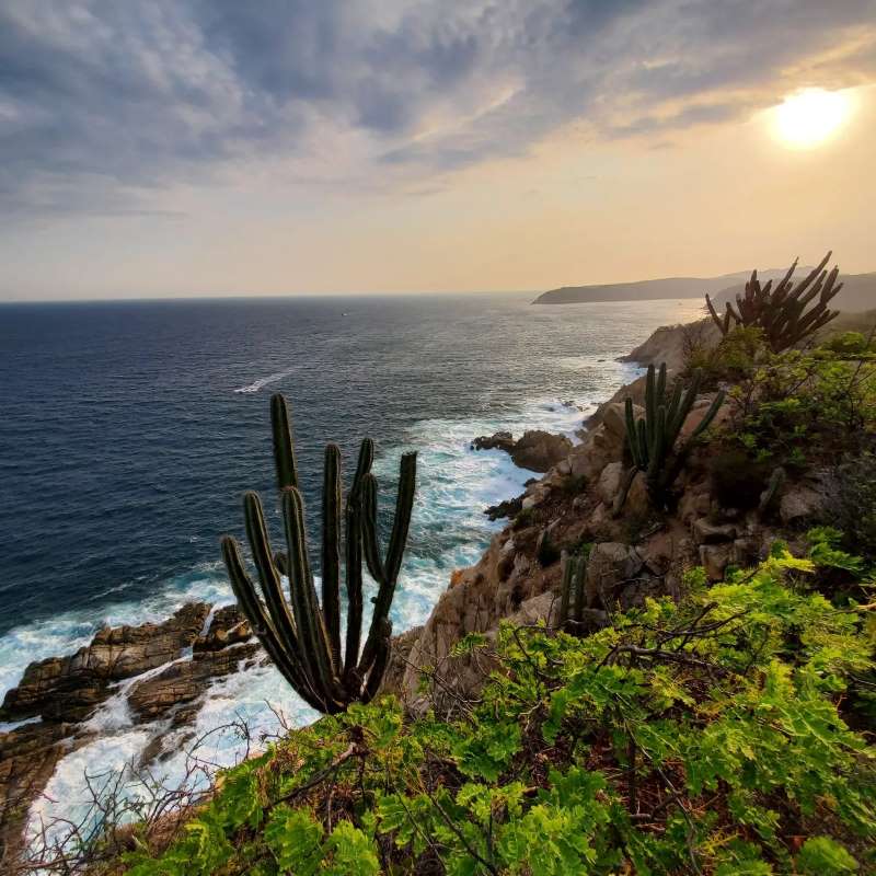 Huatulco Mexico Cliff by the ocean at sunset