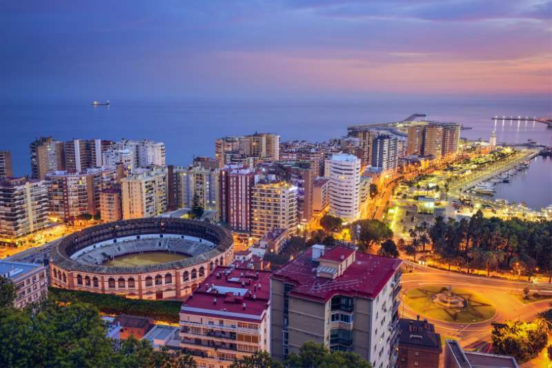 Malaga Spain cityscape at night digital nomad destination