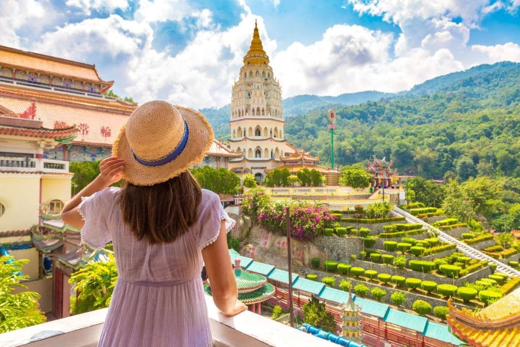 Unusual digital nomad destinations photo of woman in dress at Kek Lok Si Temple in Georgetown Penang island Malaysia 