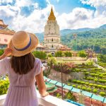 Unusual digital nomad destinations photo of woman in dress at Kek Lok Si Temple in Georgetown Penang island Malaysia