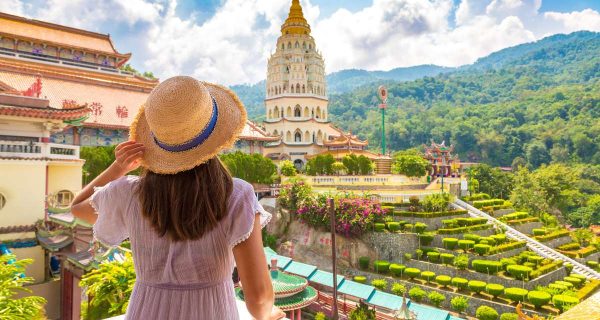 Unusual digital nomad destinations photo of woman in dress at Kek Lok Si Temple in Georgetown Penang island Malaysia