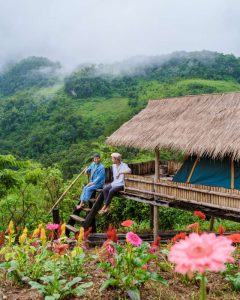 two men by but on Doi Luang Chiang Dao mountain in Thailand
