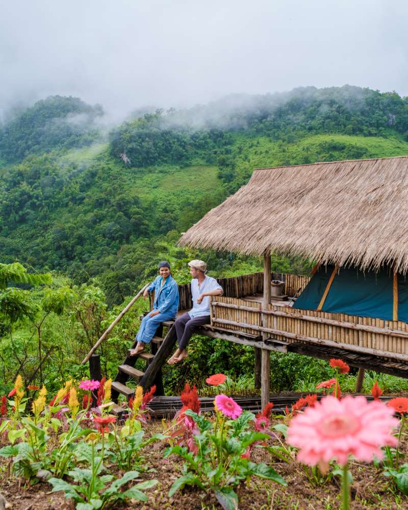 two men by but on Doi Luang Chiang Dao mountain in Thailand 