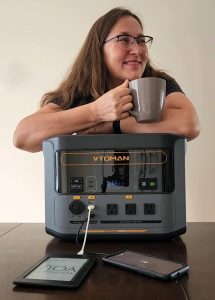 VTOMAN FlashSpeed 1500 charging phone kindle with happy woman holding mug of tea