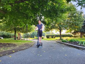 Charles driving the Ninebot E3 Pro Scooter in the park