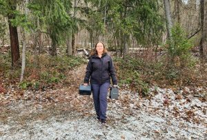 Bluetti Elite 30 V2 solar panel and BLUETTI SORA 60 Solar Panel woman walking through forest