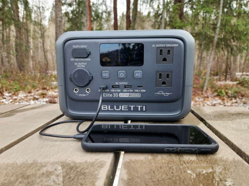 charging phone on picnic table with Bluetti Elite 30 V2