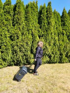 BLUETTI Elite 400 on grass pulled by handle by woman
