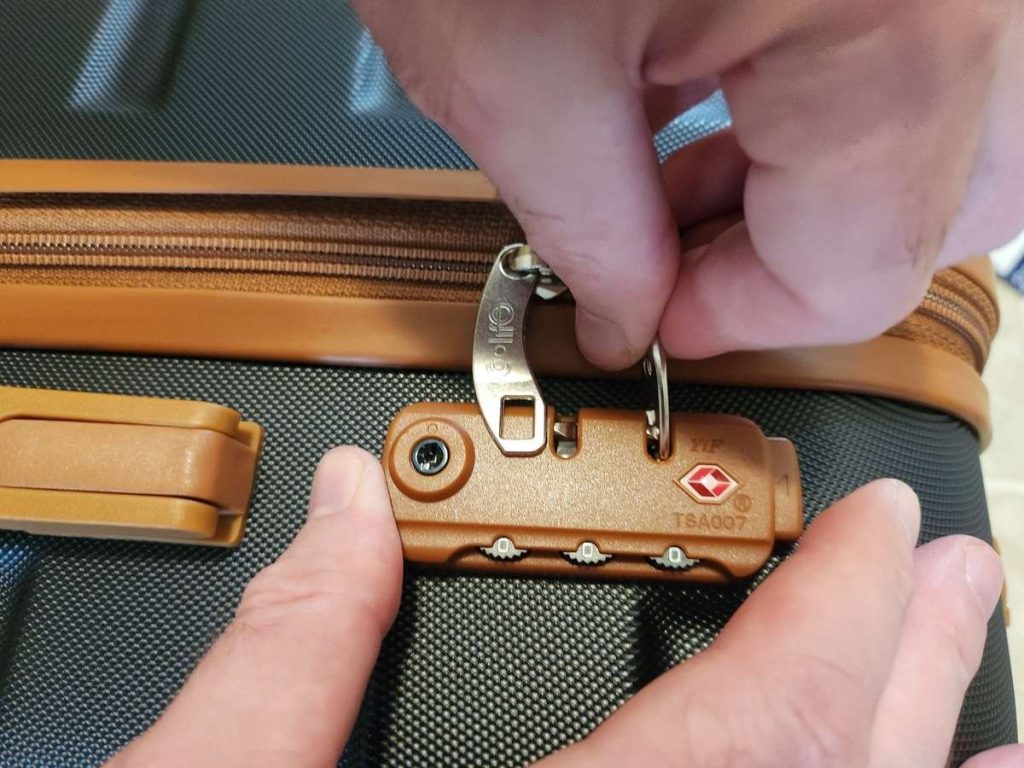 Opening the zipper lock on the Coolife hardshell suitcase