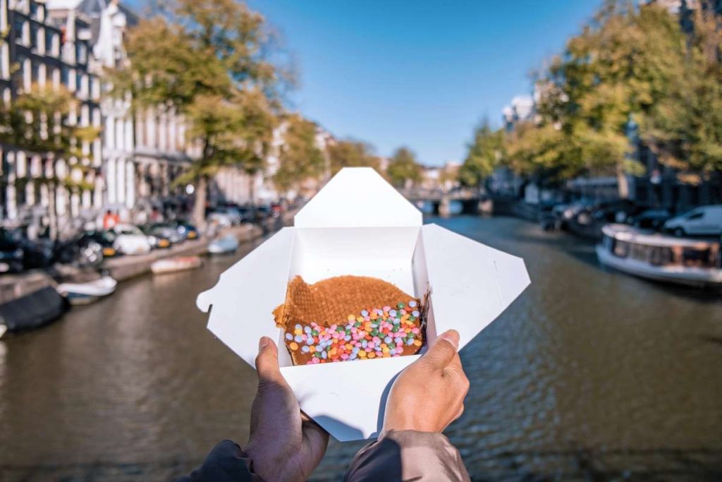 stroopwafel amsterdam in take out box by canal and boats DP