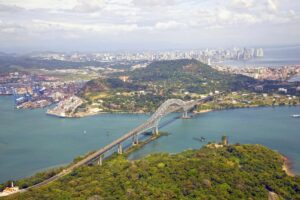 Aerial view of the Bridge of the Americas at the Pacific entrance to the Panama Canal with Panama City in the background